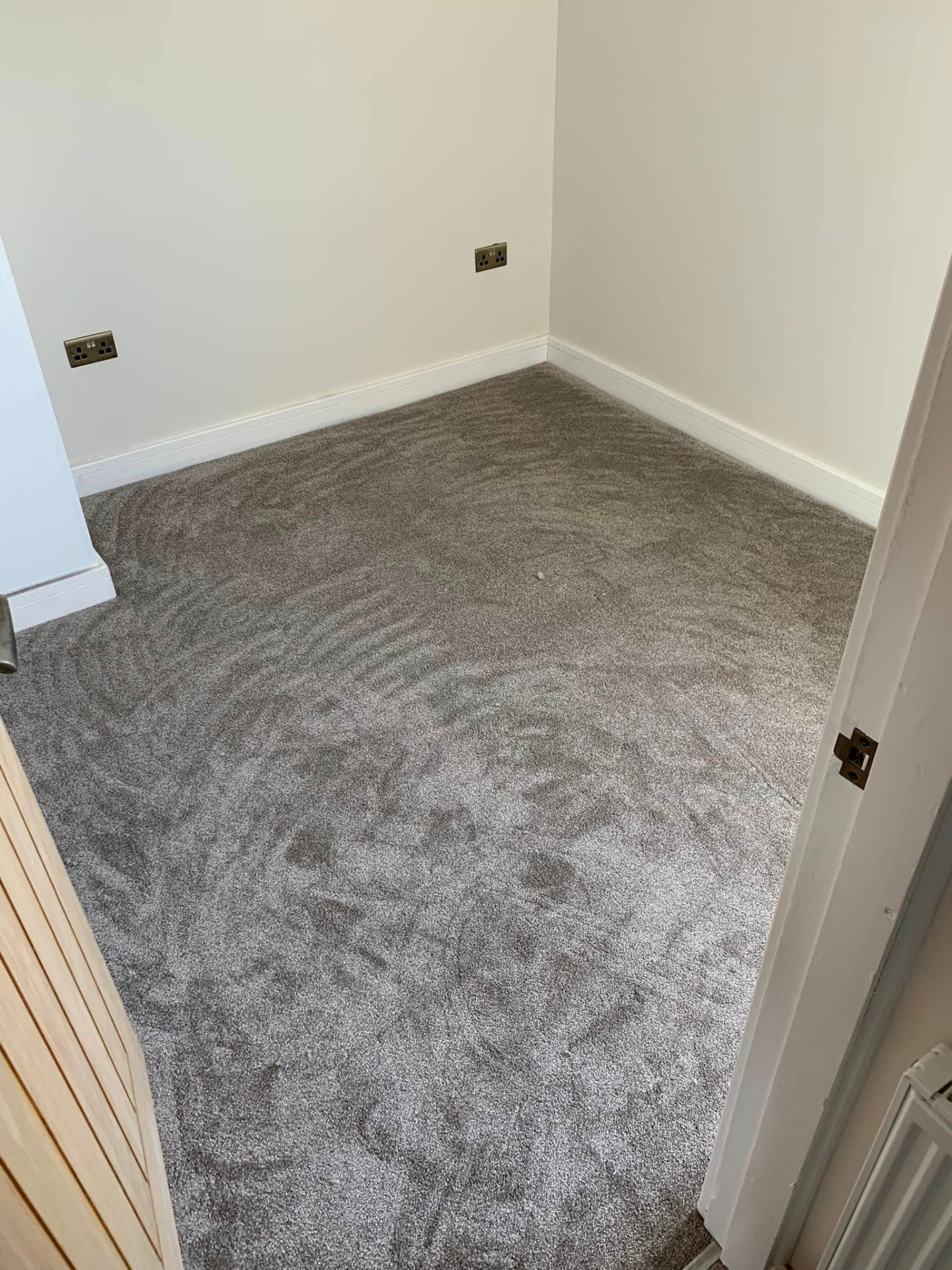 Grey carpet fitted to a neat finish in a Carlisle bedroom